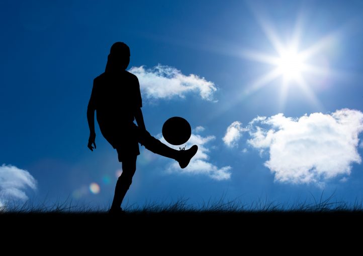 Silhouette of woman playing with ball against sky background