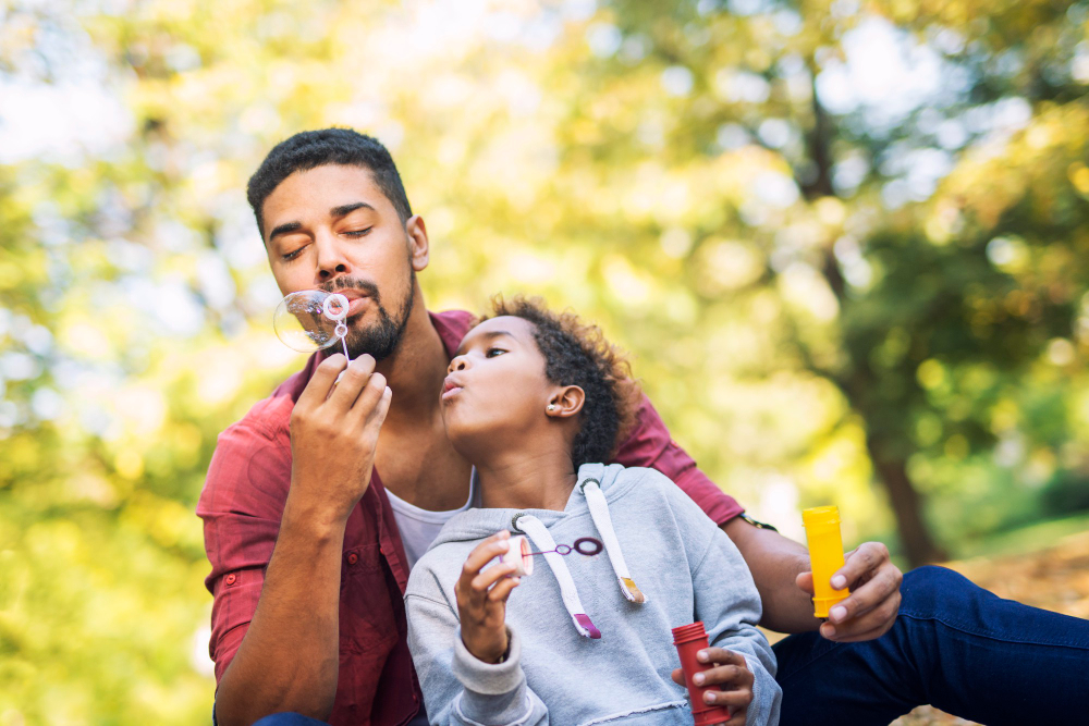father-and-daughter-blowing-soap-bubbles-enjoying-together (1)